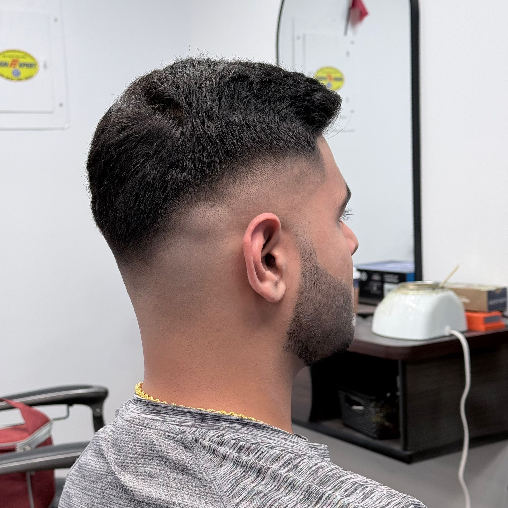 Barber working on a haircut at John A Barbershop in London Ontario